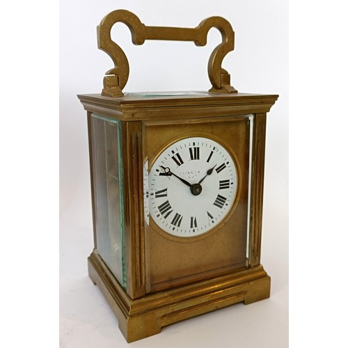 311 - A carriage clock, with an eight day movement, striking on a chime, 17 cm high, in a leather travel c... 