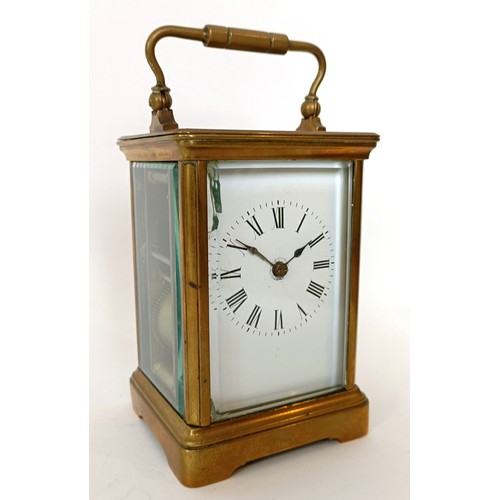 312 - A carriage clock, the 6 cm wide enamel dial with Roman numerals, striking on a gong, in a brass case... 