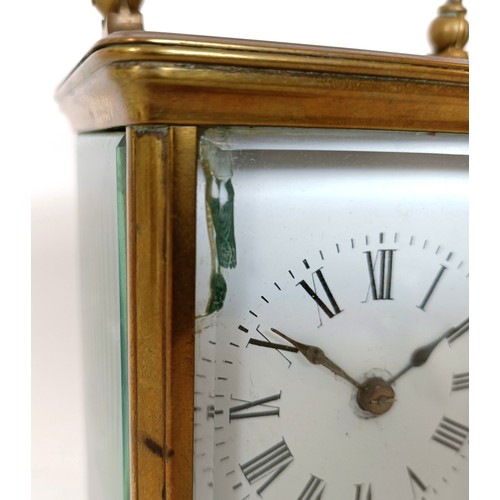312 - A carriage clock, the 6 cm wide enamel dial with Roman numerals, striking on a gong, in a brass case... 