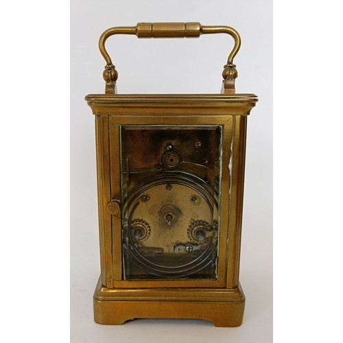 312 - A carriage clock, the 6 cm wide enamel dial with Roman numerals, striking on a gong, in a brass case... 
