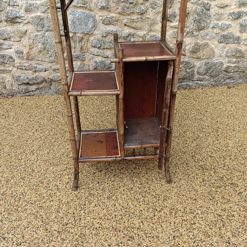961 - An unusual Aesthetic period bamboo open cabinet, with a stylised pagoda top and lacquered panels, 18... 