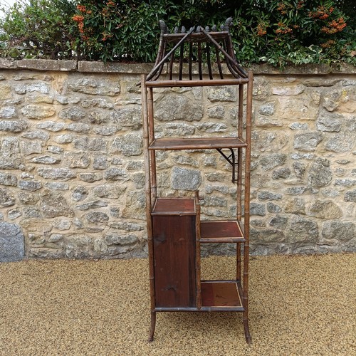 961 - An unusual Aesthetic period bamboo open cabinet, with a stylised pagoda top and lacquered panels, 18... 