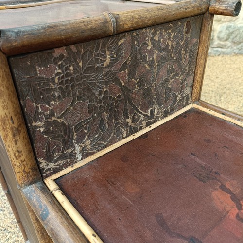 961 - An unusual Aesthetic period bamboo open cabinet, with a stylised pagoda top and lacquered panels, 18... 