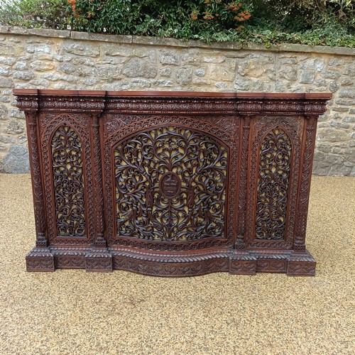 971 - A 19th century Burmese serpentine shaped front cabinet, with carved and pierced decorated and having... 