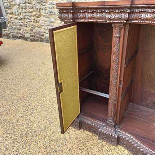 971 - A 19th century Burmese serpentine shaped front cabinet, with carved and pierced decorated and having... 
