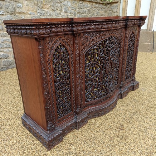 971 - A 19th century Burmese serpentine shaped front cabinet, with carved and pierced decorated and having... 