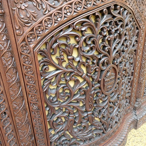 971 - A 19th century Burmese serpentine shaped front cabinet, with carved and pierced decorated and having... 
