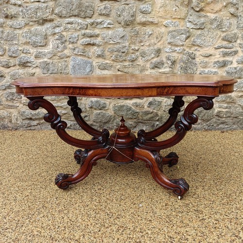 1012 - A 19th century walnut centre table, with a carved basket base, 138 cm wide