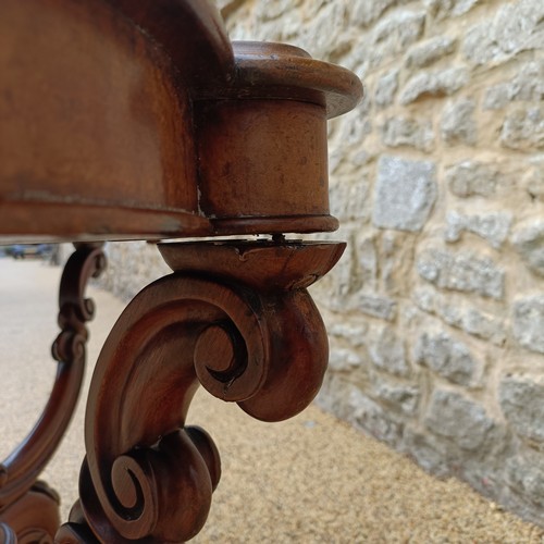 1012 - A 19th century walnut centre table, with a carved basket base, 138 cm wide