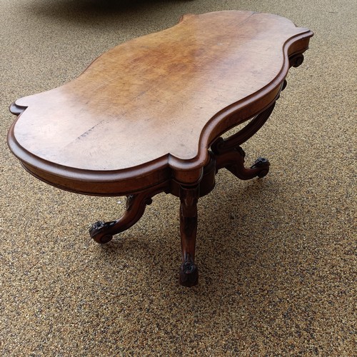 1012 - A 19th century walnut centre table, with a carved basket base, 138 cm wide