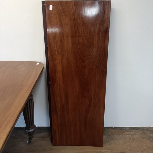 997 - A 19th century mahogany extending dining table, on turned reeded tapering legs to casters, the top, ... 