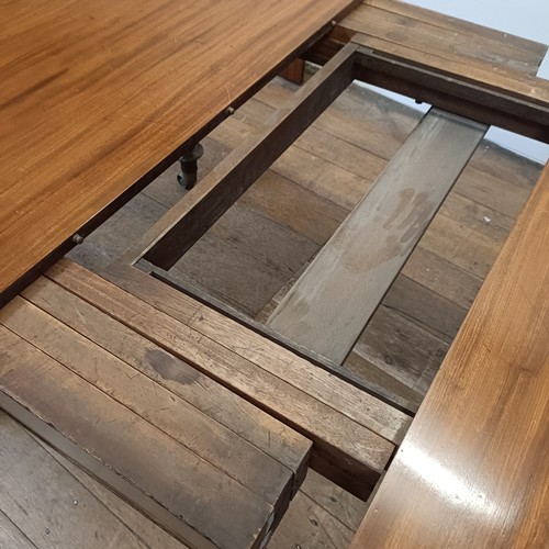 997 - A 19th century mahogany extending dining table, on turned reeded tapering legs to casters, the top, ... 