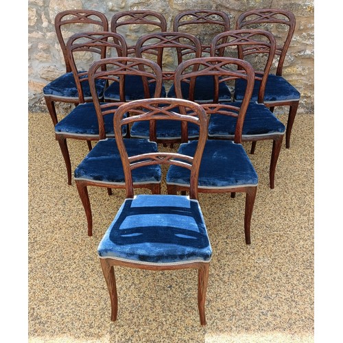 985 - An unusual set of ten Black Forest style carved dining chairs, with padded seats (10)