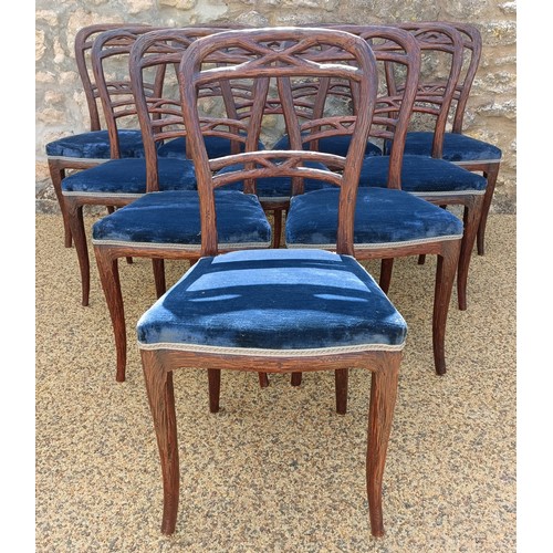 985 - An unusual set of ten Black Forest style carved dining chairs, with padded seats (10)