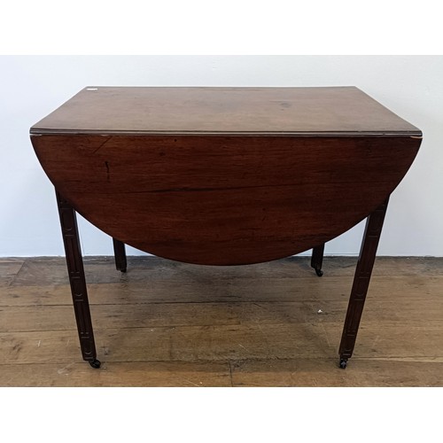 975 - A 19th century mahogany Pembroke table, with a blind fret carved frieze and legs, 84 cm wide