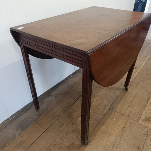 975 - A 19th century mahogany Pembroke table, with a blind fret carved frieze and legs, 84 cm wide