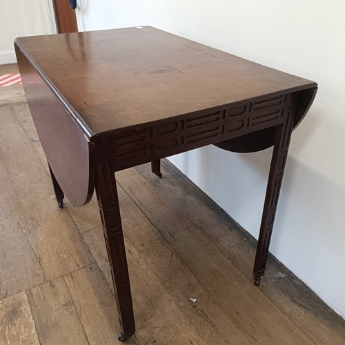 975 - A 19th century mahogany Pembroke table, with a blind fret carved frieze and legs, 84 cm wide