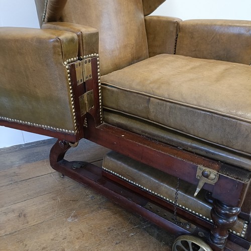 965 - A 19th century invalids reclining leather upholstered armchair, with brass mounts and wheels, J Ward... 
