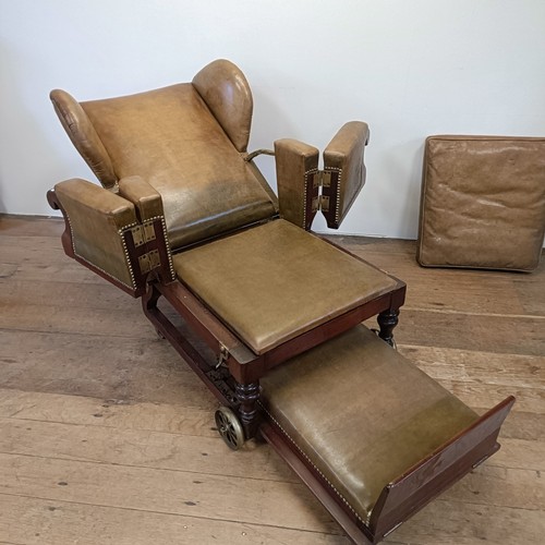 965 - A 19th century invalids reclining leather upholstered armchair, with brass mounts and wheels, J Ward... 