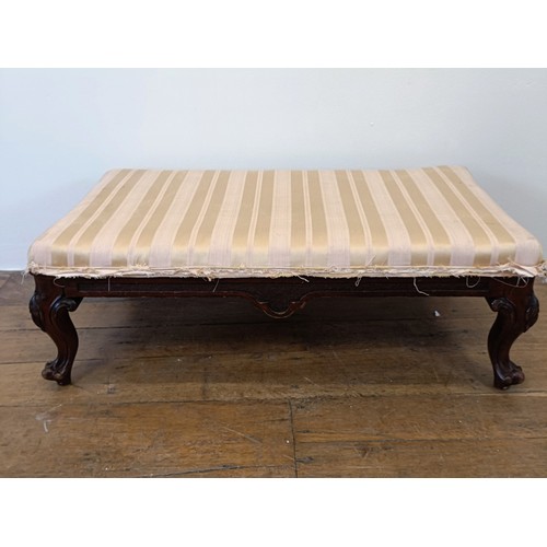 977 - A mahogany low stool, on carved cabriole legs, 96 cm wide