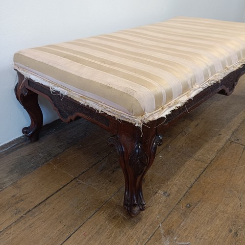 977 - A mahogany low stool, on carved cabriole legs, 96 cm wide