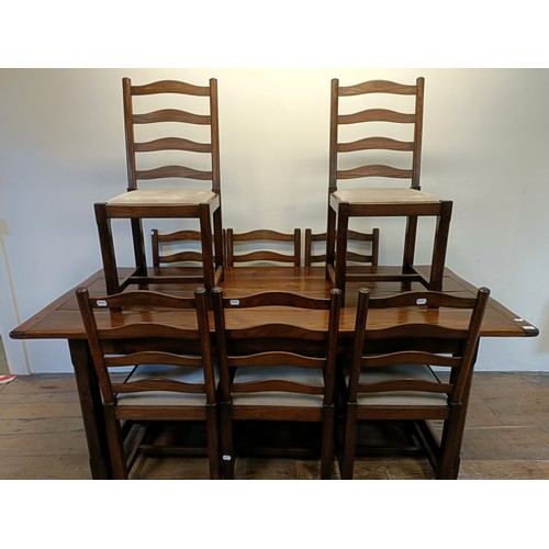 976 - An oak refectory type dining table, the top 90  x 200 cm, and a set of eight ladderback dining chair... 