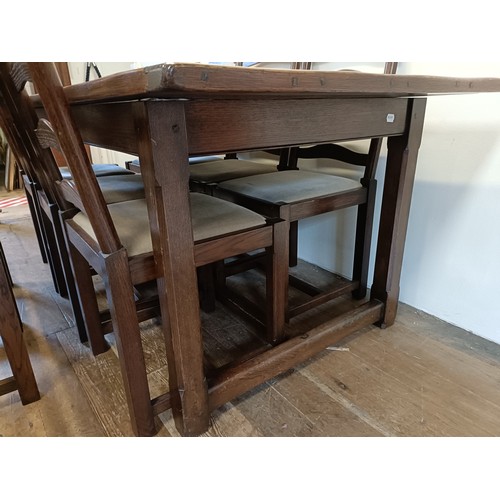 976 - An oak refectory type dining table, the top 90  x 200 cm, and a set of eight ladderback dining chair... 