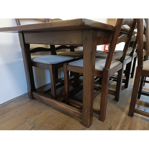976 - An oak refectory type dining table, the top 90  x 200 cm, and a set of eight ladderback dining chair... 