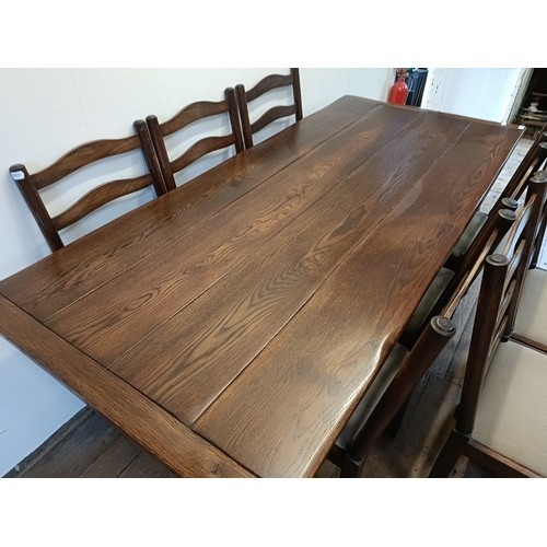 976 - An oak refectory type dining table, the top 90  x 200 cm, and a set of eight ladderback dining chair... 