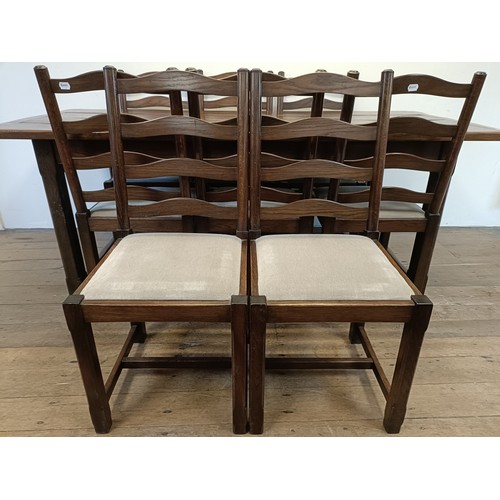 976 - An oak refectory type dining table, the top 90  x 200 cm, and a set of eight ladderback dining chair... 