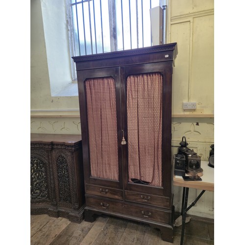 962 - A mahogany cupboard, 205 cm high, 114 cm wide