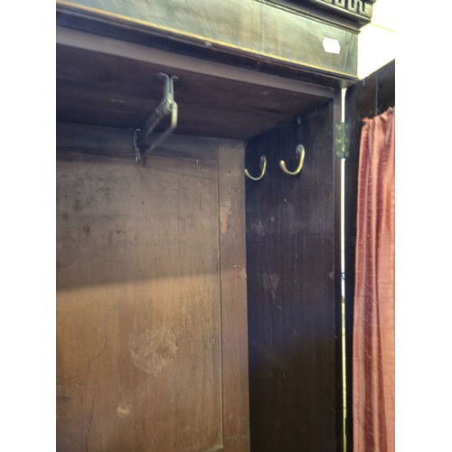 962 - A mahogany cupboard, 205 cm high, 114 cm wide