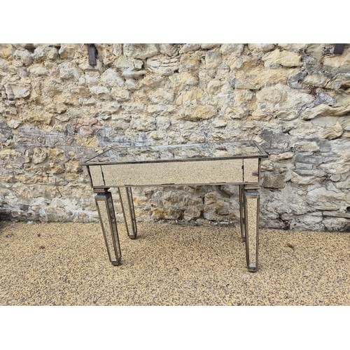 990 - A contemporary mirrored side table, 108 cm wide