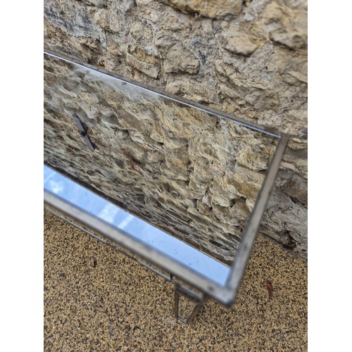 990 - A contemporary mirrored side table, 108 cm wide