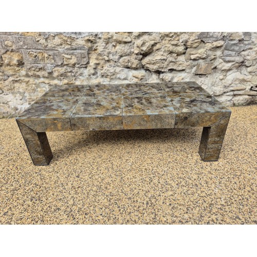 991 - A glass veneered coffee table, 25 cm high, the top 124 x 64 cm, some losses and cracks
