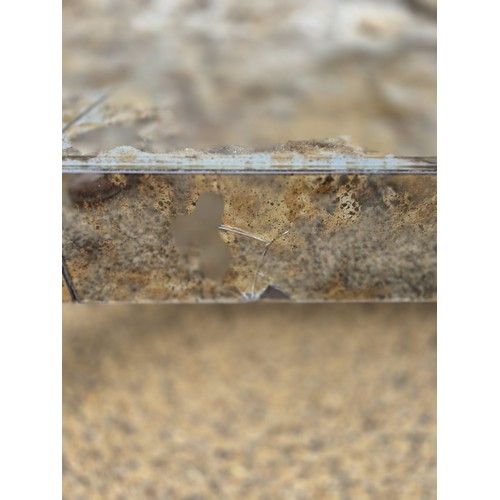 991 - A glass veneered coffee table, 25 cm high, the top 124 x 64 cm, some losses and cracks
