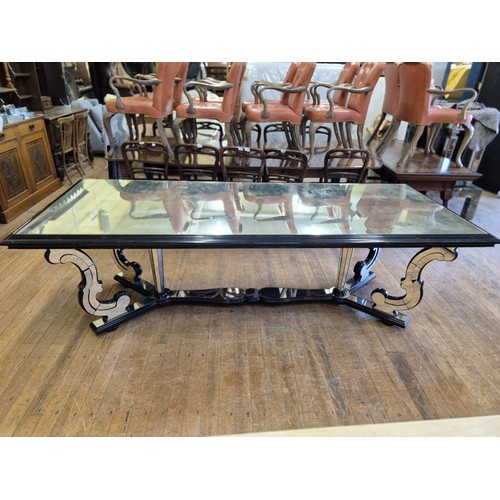 1004 - A late 20th century Italian mirrored and ebonised dining table, with scrolled supports, the top 240 ... 