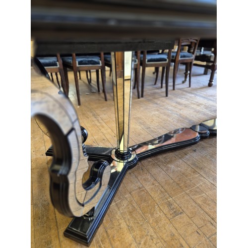 1004 - A late 20th century Italian mirrored and ebonised dining table, with scrolled supports, the top 240 ... 