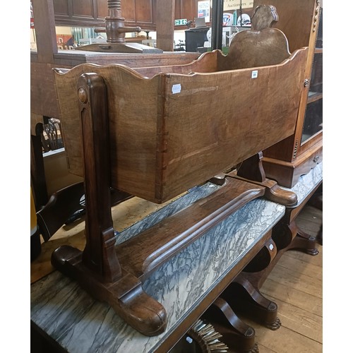 899 - A walnut cot, 103 cm wide