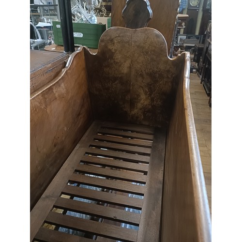 899 - A walnut cot, 103 cm wide