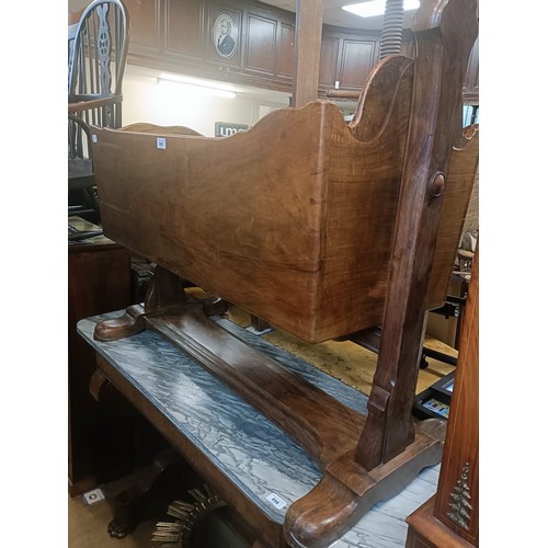 899 - A walnut cot, 103 cm wide
