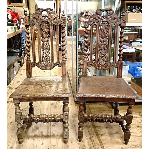 981 - A pair of carved oak hall chairs (2)