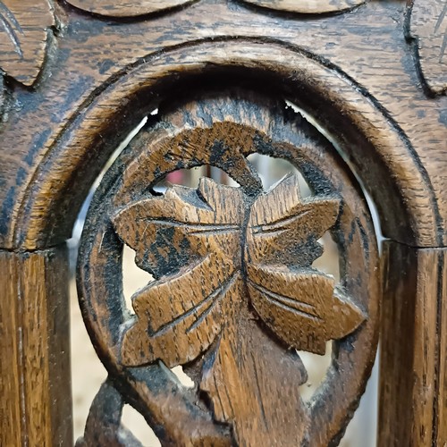 981 - A pair of carved oak hall chairs (2)