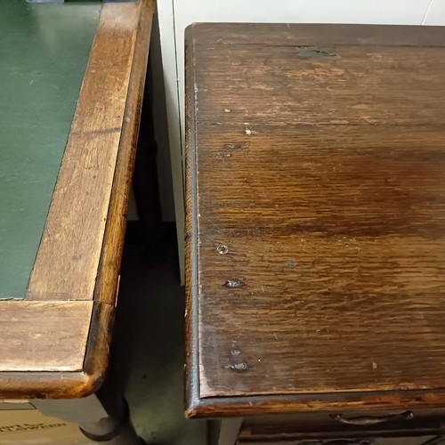 983 - An oak kneehole desk, with a brushing slide and nine drawers, 92 cm wide