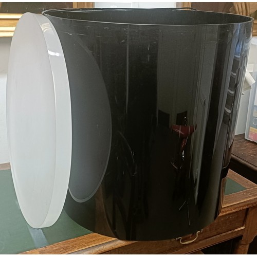 1009 - A large black plastic side table, 56 cm diameter, with a frosted Perspex round base, 54 cm diameter ... 
