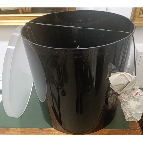1009 - A large black plastic side table, 56 cm diameter, with a frosted Perspex round base, 54 cm diameter ... 