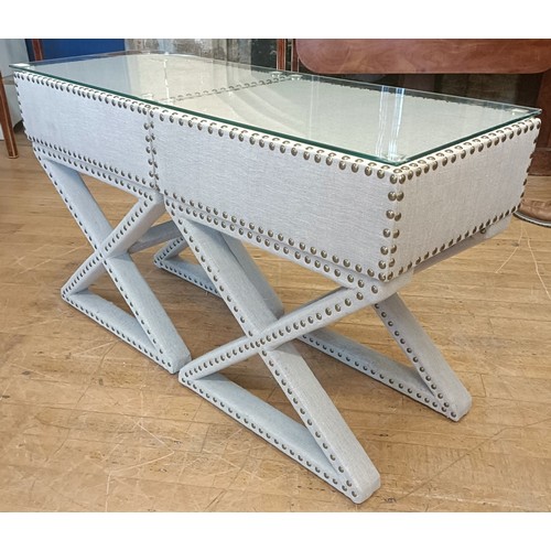 1016 - A pair of cloth covered and studded bedside tables, connected as one, each 50 cm wide