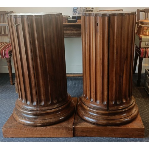 1017 - A pair of walnut bedside cupboards, in the form of fluted columns, 40 cm diameter, 89 cm high