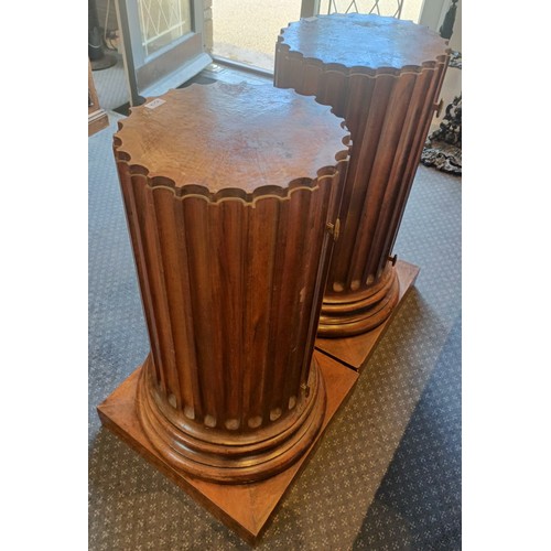 1017 - A pair of walnut bedside cupboards, in the form of fluted columns, 40 cm diameter, 89 cm high