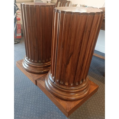 1017 - A pair of walnut bedside cupboards, in the form of fluted columns, 40 cm diameter, 89 cm high